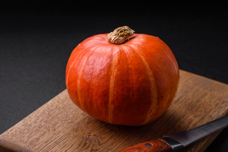 Beautiful fresh round pumpkins in orange color on a dark concrete background. Preparing for the Halloween celebrationの写真素材