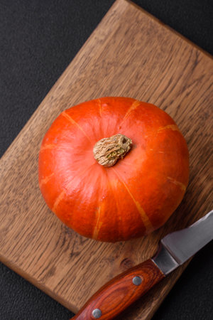 Beautiful fresh round pumpkins in orange color on a dark concrete background. Preparing for the Halloween celebrationの写真素材