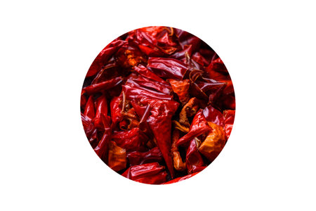 Pieces of dried paprika, preparation of powder spice for various dishes, against a dark concrete...