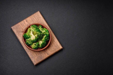 Delicious fresh green broccoli steamed in a ceramic plate on a textured concrete backgroundの写真素材