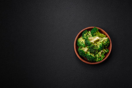 Delicious fresh green broccoli steamed in a ceramic plate on a textured concrete backgroundの写真素材