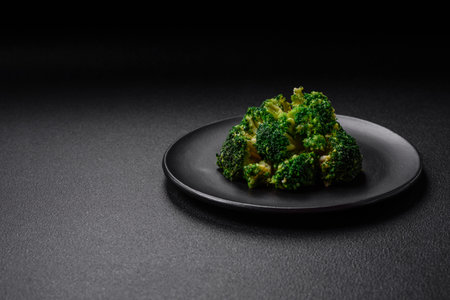 Delicious fresh green broccoli steamed in a ceramic plate on a textured concrete backgroundの写真素材
