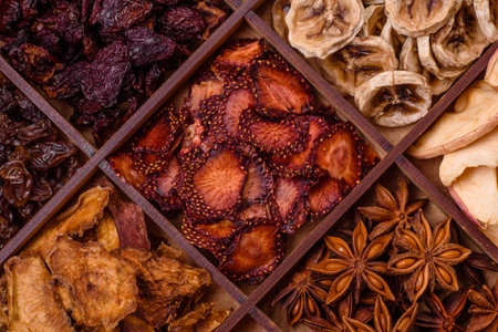 Variation of dry fruits strawberry, apple, cherry, banana, peach, plum and star anise in a box on a...