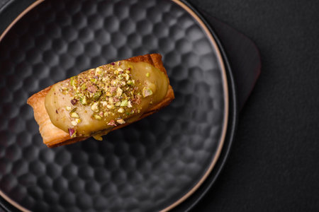 Round puff pastry croissant with raspberry filling or new york roll on dark concrete background