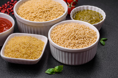 Raw whole grain orzo pasta as an ingredient for a delicious dish. Mediterranean cuisine dish