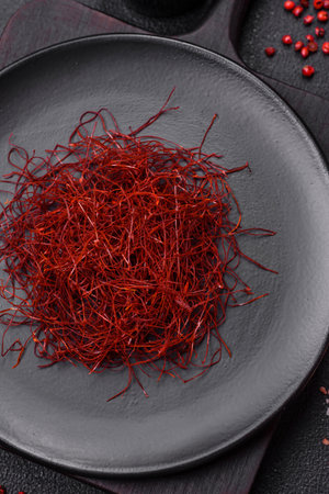 Red thin hot chili threads on a dark background. For decorating Asian dishes