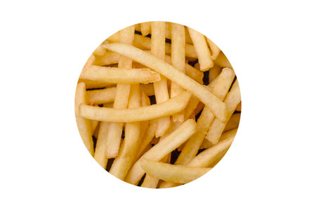 Fresh delicious crispy French fries with salt and spices on a dark concrete background