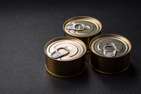 Round metal can with canned fish or meat with a key on a concrete texture backgroundの写真素材