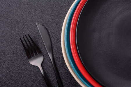 Beautiful empty round ceramic plate on a concrete background. Kitchen utensils for serving food on the tableの写真素材