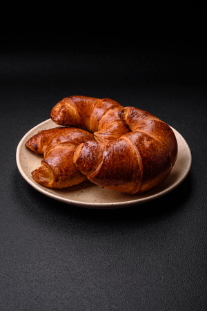 Delicious baked crispy croissants as an element of an invigorating, nutritious breakfast. Fresh baked goods for your tableの写真素材