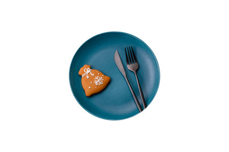 Beautiful festive Christmas composition of an empty plate, tangerine, gingerbreads and star anise on a dark textured backgroundの写真素材