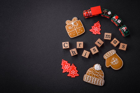 Beautiful Christmas composition with copy space with an inscription in wooden cubes on a black concrete backgroundの写真素材