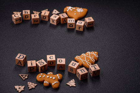 Beautiful Christmas composition with copy space with an inscription in wooden cubes on a black concrete backgroundの写真素材