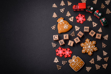 Beautiful Christmas composition with copy space with an inscription in wooden cubes on a black concrete backgroundの写真素材