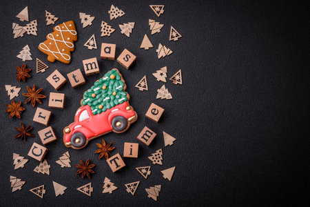 Beautiful Christmas composition with copy space with an inscription in wooden cubes on a black concrete backgroundの写真素材