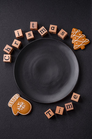 Beautiful Christmas composition with copy space with an inscription in wooden cubes on a black concrete backgroundの写真素材