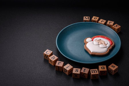 Beautiful Christmas composition with copy space with an inscription in wooden cubes on a black concrete backgroundの写真素材
