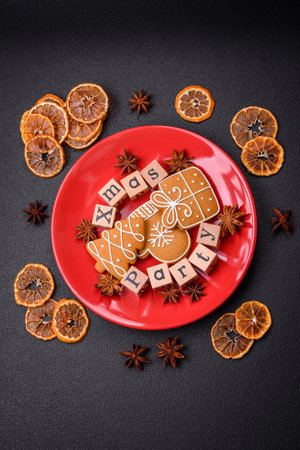 Christmas party inscription with wooden cubes on a dark concrete background. Postcard with copy space for your designの写真素材