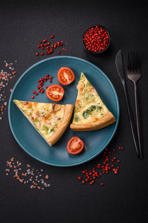Delicious quiche with broccoli, cheese, chicken, spices and herbs on a dark concrete backgroundの写真素材