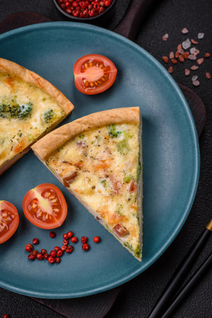 Delicious quiche with broccoli, cheese, chicken, spices and herbs on a dark concrete background
