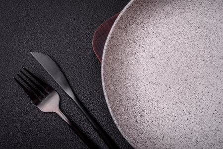 Empty round ceramic plate as an item of kitchen utensils on a textured concrete backgroundの写真素材