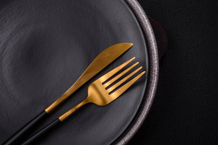Empty round ceramic plate as an item of kitchen utensils on a textured concrete backgroundの写真素材