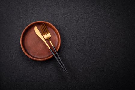 Bumpy empty ceramic plate on a textured concrete background. Kitchen utensil item