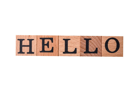 The inscription hello on wooden cubes on a dark concrete background. Can be used as part of your...