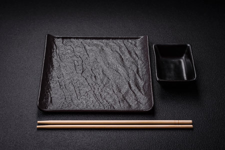 Square empty ceramic plate on textured concrete background. Kitchen utensil itemの写真素材