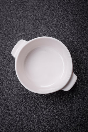 Beautiful empty white ceramic gravy boat on a textured concrete background. Kitchen utensil itemの写真素材