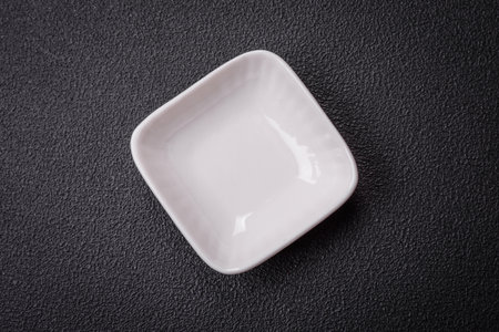 Beautiful empty white ceramic gravy boat on a textured concrete background. Kitchen utensil itemの写真素材
