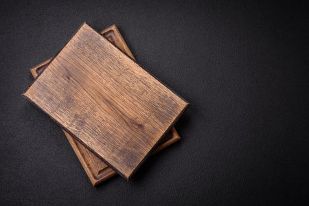 Empty wooden cutting board for preparing ingredients for preparing a delicious dish. Kitchen utensilsの写真素材
