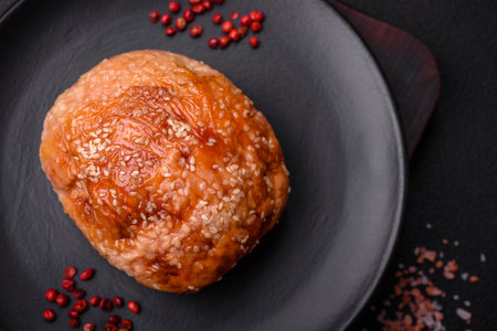 Delicious baked chicken or turkey meat roll with salt and spices on a textured concrete backgroundの写真素材