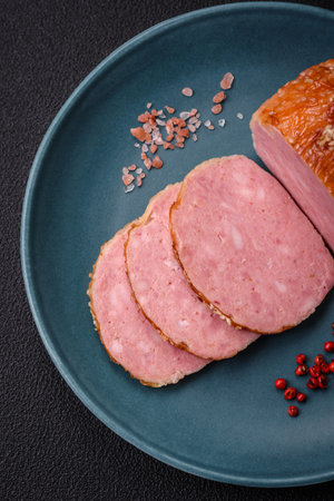 Delicious baked chicken or turkey meat roll with salt and spices on a textured concrete background