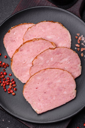 Delicious baked chicken or turkey meat roll with salt and spices on a textured concrete background