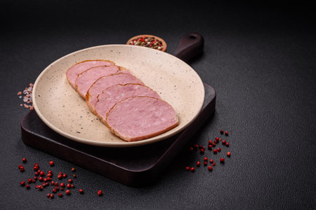 Delicious baked chicken or turkey meat roll with salt and spices on a textured concrete backgroundの写真素材
