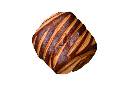 Delicious sweet crispy fresh baked cinnamon bun on dark concrete backgroundの写真素材