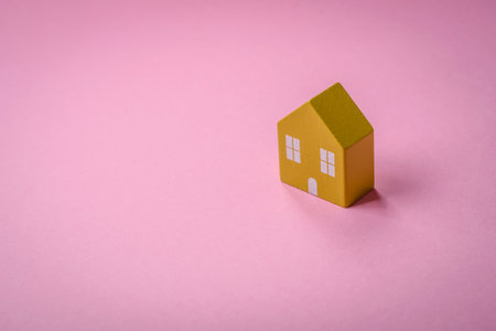 A small wooden house as an idea for investing in your own home and achieving the goal of buying real estate. Background for your ideaの写真素材