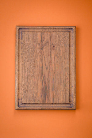 Empty wooden rectangular cutting board on a plain background, flatley with copy space. Kitchen utensils in home kitchenの写真素材