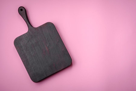 Empty wooden rectangular cutting board on a plain background, flatley with copy space. Kitchen utensils in home kitchenの写真素材