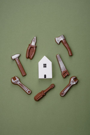 Repair or home improvement tools and a house model on a plain background. Background for your designの写真素材