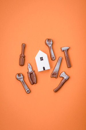 Repair or home improvement tools and a house model on a plain background. Background for your designの写真素材
