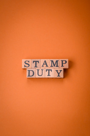 The inscription Stamp Duty made of wooden cubes on a plain background. Can be used for your designの写真素材
