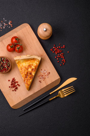 Delicious crispy quiche cut into slices with cheese, broccoli, tomatoes, salt, spices and herbs on a...