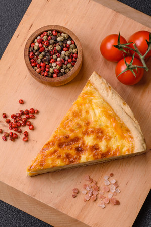 Delicious crispy quiche cut into slices with cheese, broccoli, tomatoes, salt, spices and herbs on a...