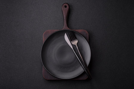 Cutlery fork, knife and spoon on a dark textured concrete background. Kitchen items and accessoriesの写真素材