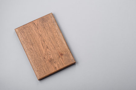 Empty wooden cutting board on gray textured concrete background. Cutlery, preparation for dinner
