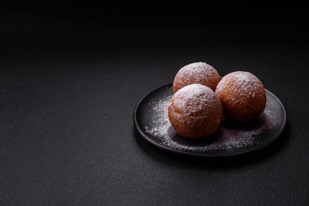 Round homemade cheese donuts glazed with citrus flavor on a dark concrete backgroundの写真素材