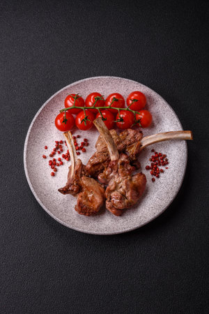 Delicious juicy meat on the bone or rack of lamb or grilled veal with salt, spices and herbsの写真素材