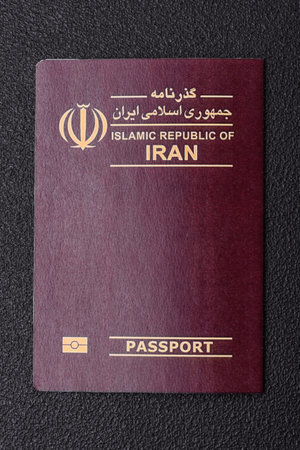 Physical paper international passport of Iranian citizen on dark concrete backgroundの写真素材